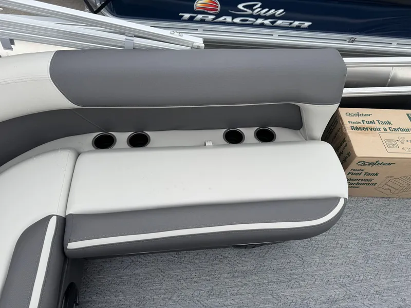 Slide: The Image of 2026 Sun Tracker Bass Buggy 16 XL boat interior with cushioned seating and cup holders. - 17