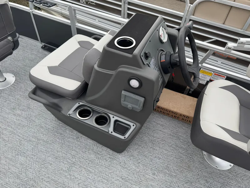 Slide: The Image of 2026 Sun Tracker Bass Buggy 16 XL boat interior with steering console and seating. - 18