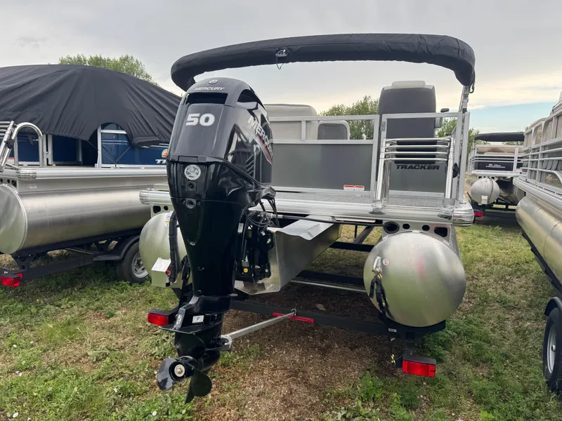 Slide: The Image of 2026 Sun Tracker Bass Buggy 16 XL pontoon boat with Mercury 50 engine, parked outdoors. - 4