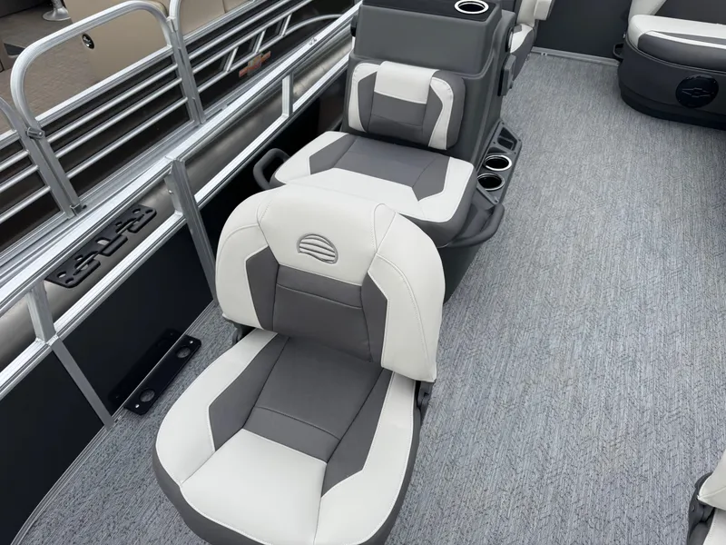 Slide: The Image of 2026 Sun Tracker Bass Buggy 16 XL interior with gray and white seating, cup holders, and carpeted flooring. - 9
