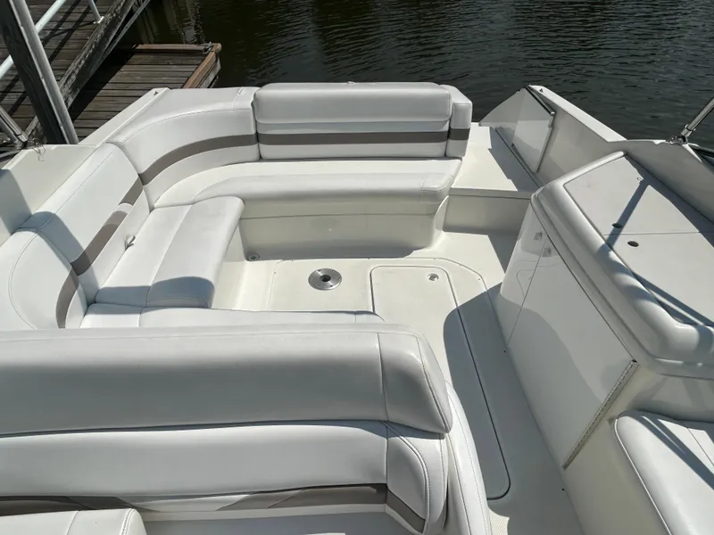 Slide: The Image of 2001 Formula 280 Sun Sport boat interior with white seating and deck, docked by water. - 15