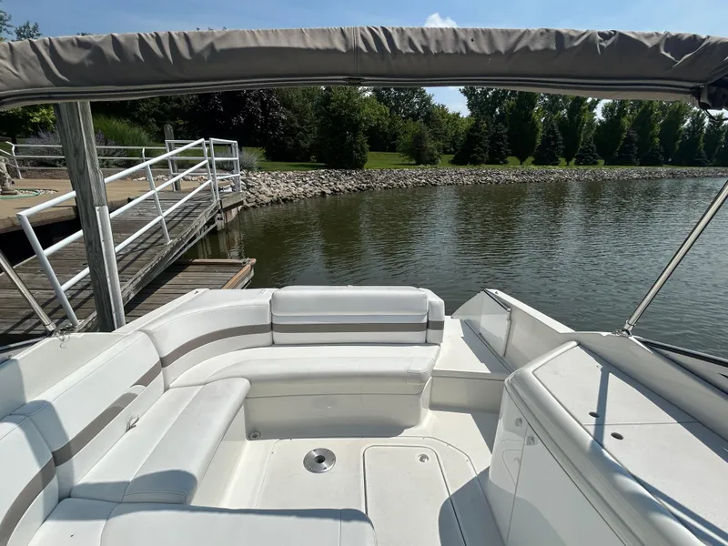 Slide: The Image of 2001 Formula 280 Sun Sport boat interior at dock, featuring white seating and canopy. - 16