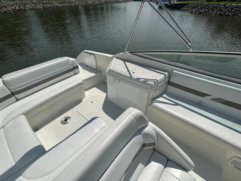 Slide: The Image of 2001 Formula 280 Sun Sport boat interior with white seating, on calm water. - 17