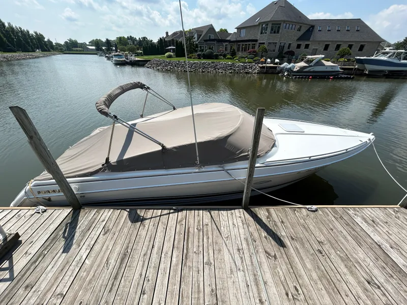 Slide: The Image of 2001 Formula 280 Sun Sport boat docked on a calm waterfront. - 2