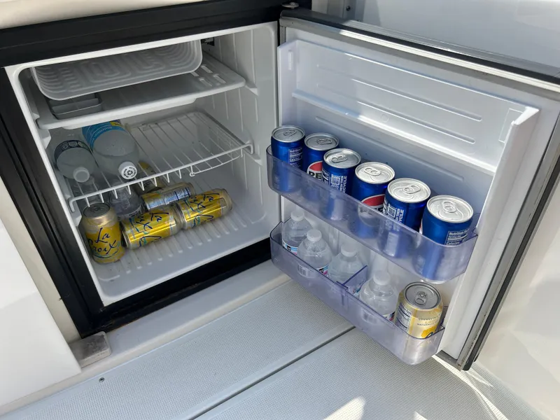 Slide: The Image of Mini fridge stocked with beverages on a 2001 Formula 280 Sun Sport boat. - 20