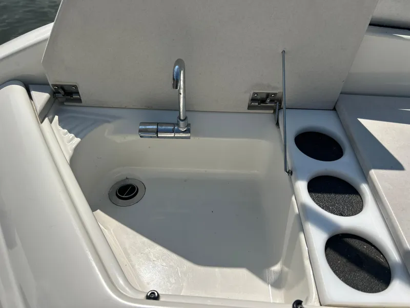 Slide: The Image of 2001 Formula 280 Sun Sport boat sink with faucet and cup holders. - 21