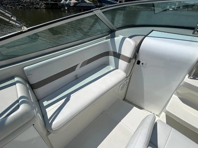 Slide: The Image of 2001 Formula 280 Sun Sport boat interior with white seating and glass windshield. - 24
