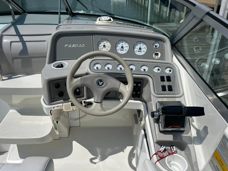 Slide: The Image of 2001 Formula 280 Sun Sport boat dashboard with steering wheel and gauges. - 30
