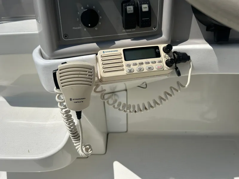 Slide: The Image of VHF radio and microphone on a 2001 Formula 280 Sun Sport boat dashboard. - 35