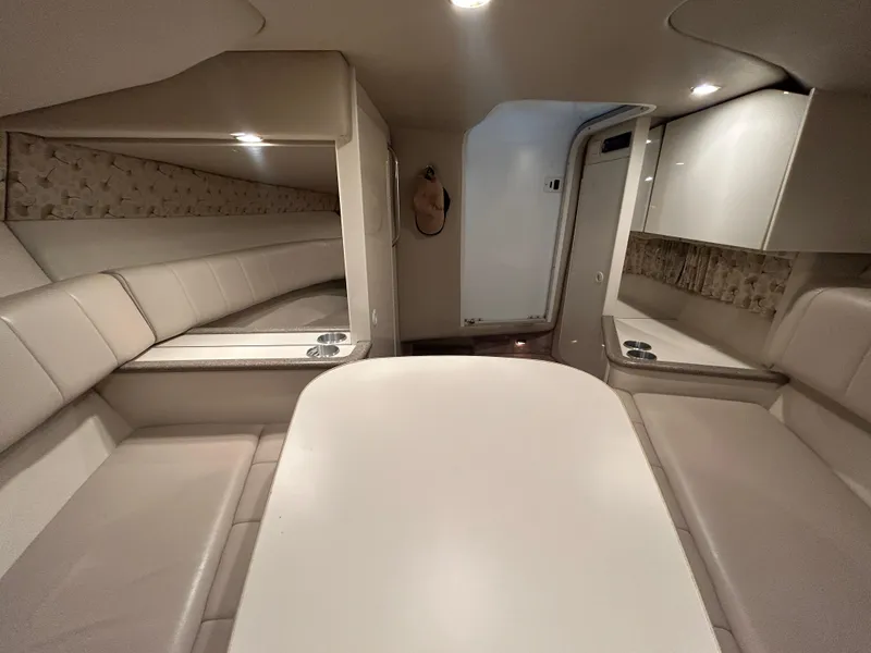 Slide: The Image of Interior of 2001 Formula 280 Sun Sport boat, featuring seating and table in a cozy cabin. - 45