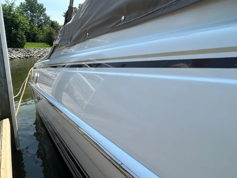 Slide: The Image of 2001 Formula 280 Sun Sport boat docked, showcasing sleek white hull and cover. - 5