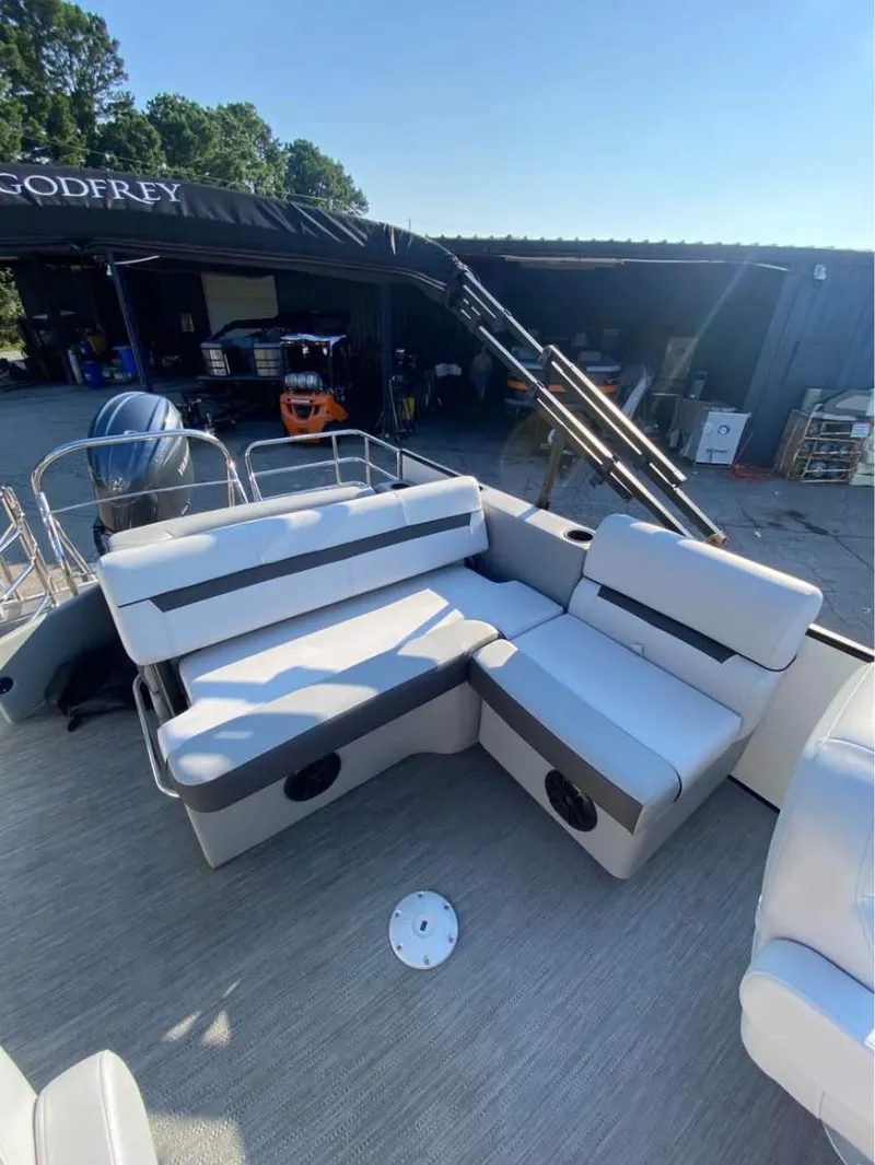 Slide: The Image of 2024 Godfrey SWEETWATER 2286 SFL pontoon boat with cushioned seating and canopy. - 7