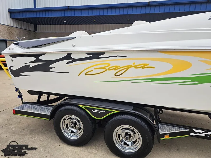 Slide: The Image of 2005 Baja 23 Outlaw boat with vibrant graphics on a trailer. - 10