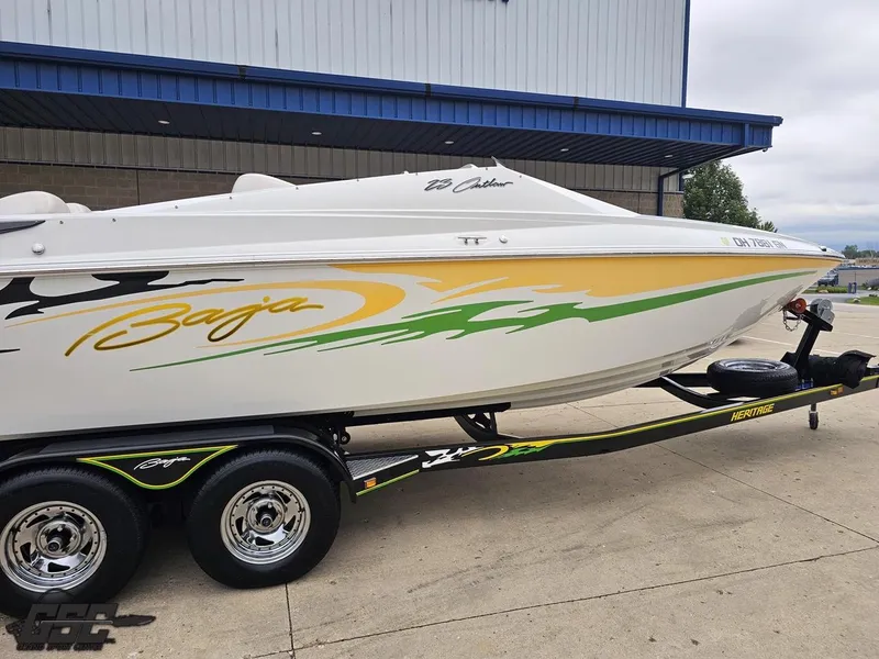 Slide: The Image of 2005 Baja 23 Outlaw boat with vibrant graphics on a trailer. - 11