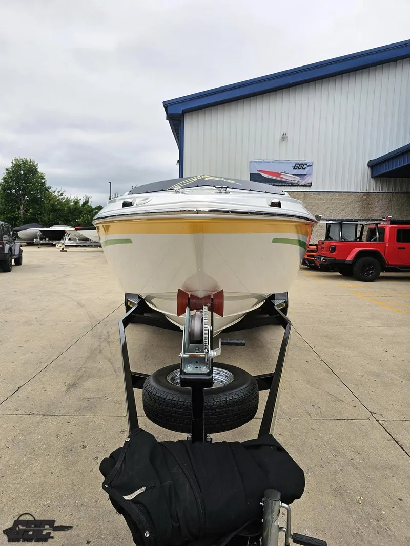 Slide: The Image of 2005 Baja 23 Outlaw boat on trailer in front of a warehouse. - 19