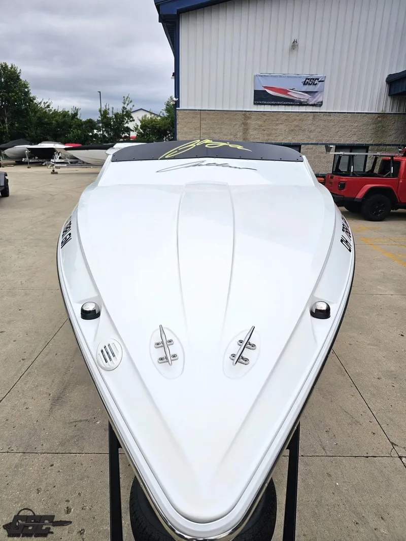 Slide: The Image of 2005 Baja 23 Outlaw boat displayed outdoors, showcasing sleek design and aerodynamic features. - 20