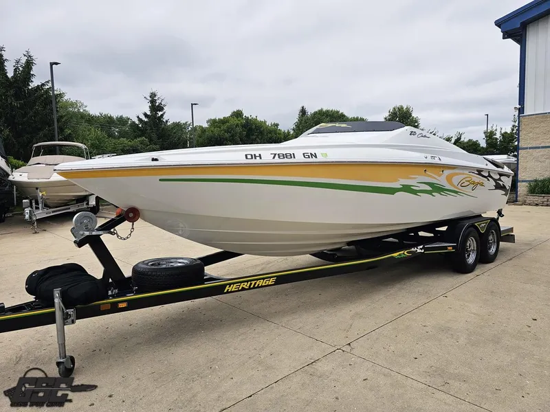 Slide: The Image of 2005 Baja 23 Outlaw speedboat on trailer, featuring vibrant graphics and sleek design. - 22