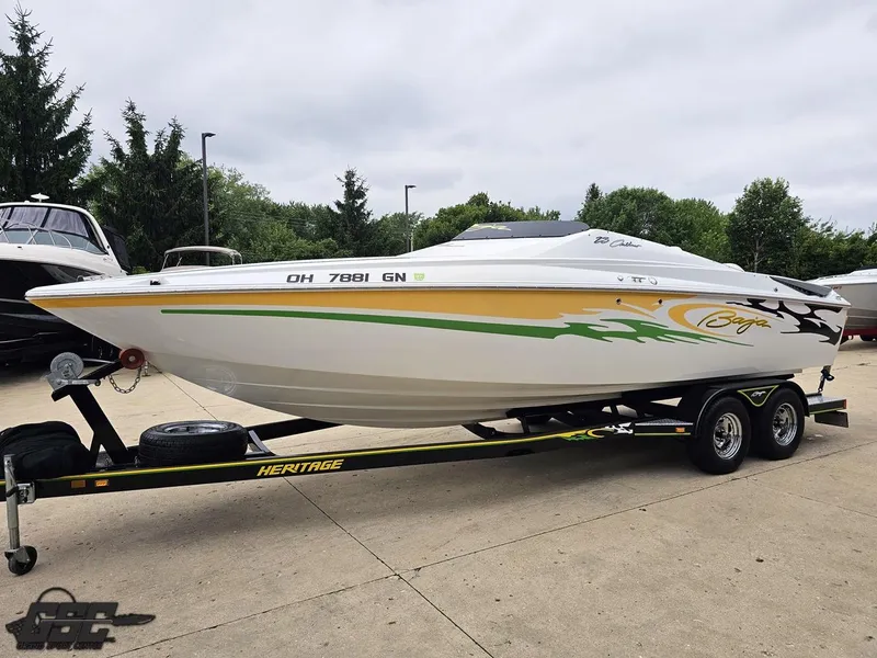 Slide: The Image of 2005 Baja 23 Outlaw speedboat on trailer, featuring vibrant graphics and sleek design. - 23