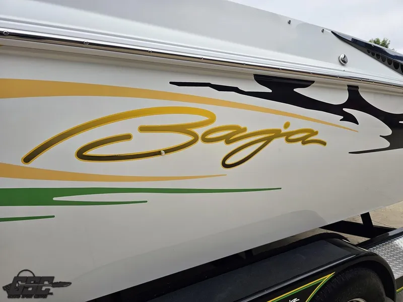 Slide: The Image of 2005 Baja 23 Outlaw boat with vibrant graphics and logo on the side. - 29