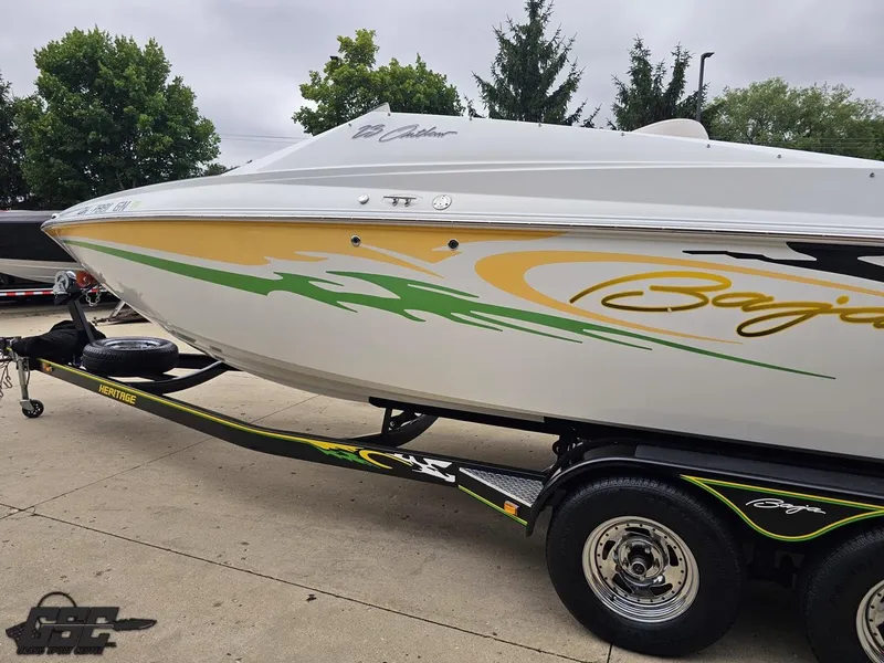 Slide: The Image of 2005 Baja 23 Outlaw boat on trailer, featuring vibrant graphics and sleek design. - 30