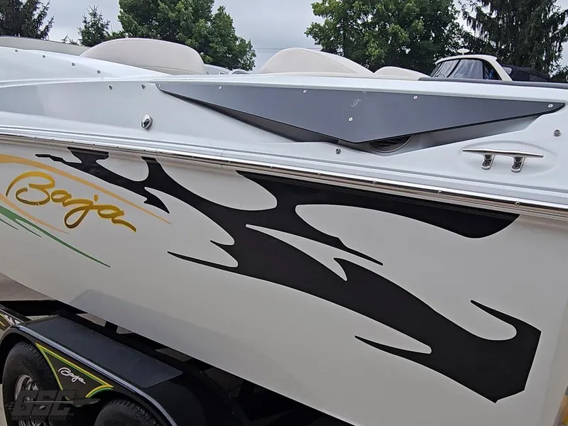 Slide: The Image of 2005 Baja 23 Outlaw boat with bold graphics and sleek design. - 33