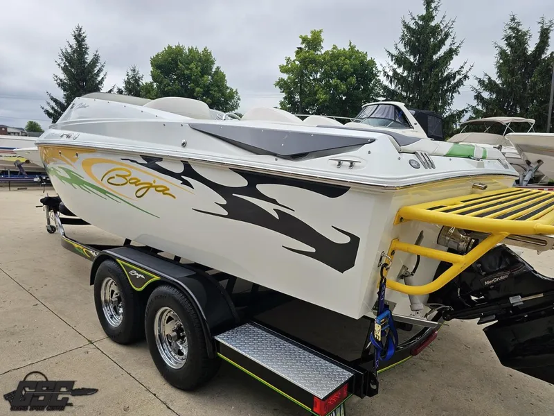 Slide: The Image of 2005 Baja 23 Outlaw boat on trailer, featuring bold graphics and sleek design. - 34