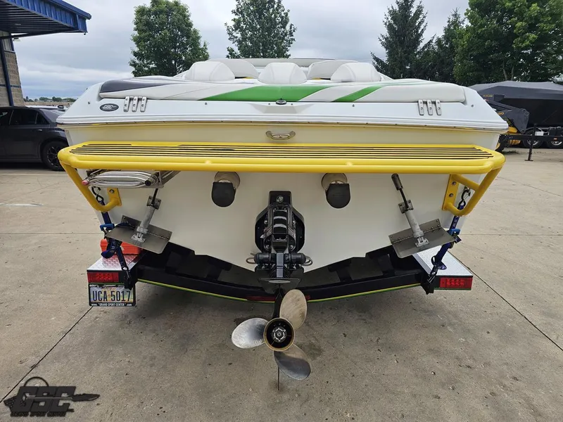 Slide: The Image of Rear view of a 2005 Baja 23 Outlaw boat with yellow accents on a trailer. - 36