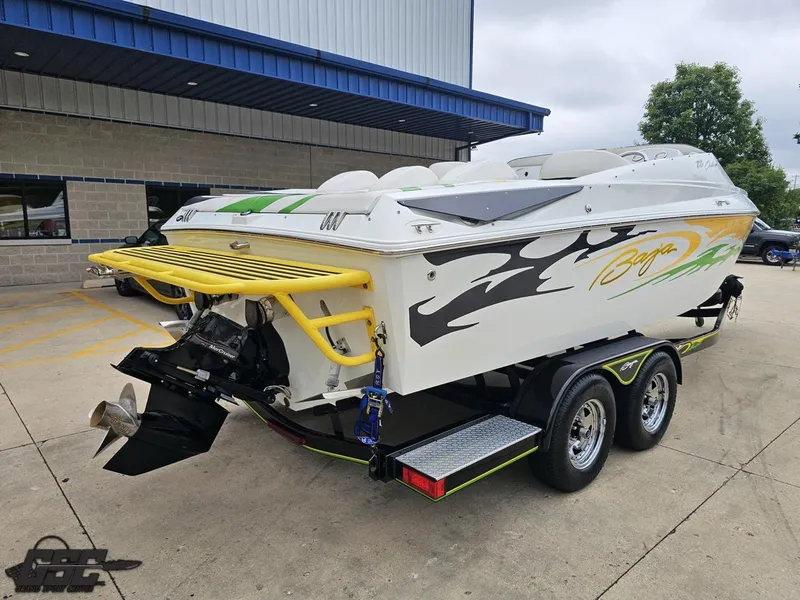 Slide: The Image of 2005 Baja 23 Outlaw speedboat on trailer, featuring vibrant graphics and dual exhaust. - 37