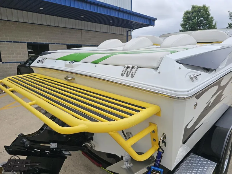 Slide: The Image of 2005 Baja 23 Outlaw boat with yellow swim platform and green accents. - 38