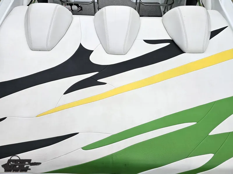 Slide: The Image of 2005 Baja 23 Outlaw boat interior with white, black, yellow, and green upholstery design. - 46