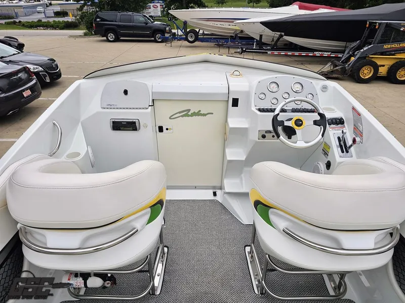 Slide: The Image of 2005 Baja 23 Outlaw boat cockpit with dual seats and control panel. - 49