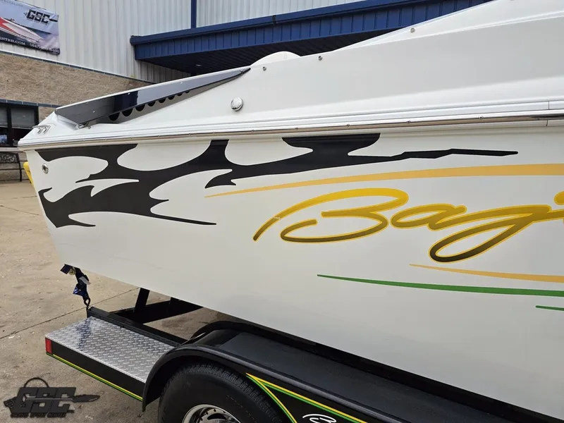 Slide: The Image of 2005 Baja 23 Outlaw boat with bold graphics on a trailer. - 9