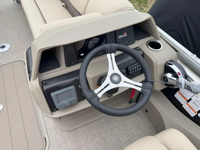 Slide: The Image of 2025 Sun Tracker SportFish 22 XP3 boat dashboard with steering wheel and controls. - 11