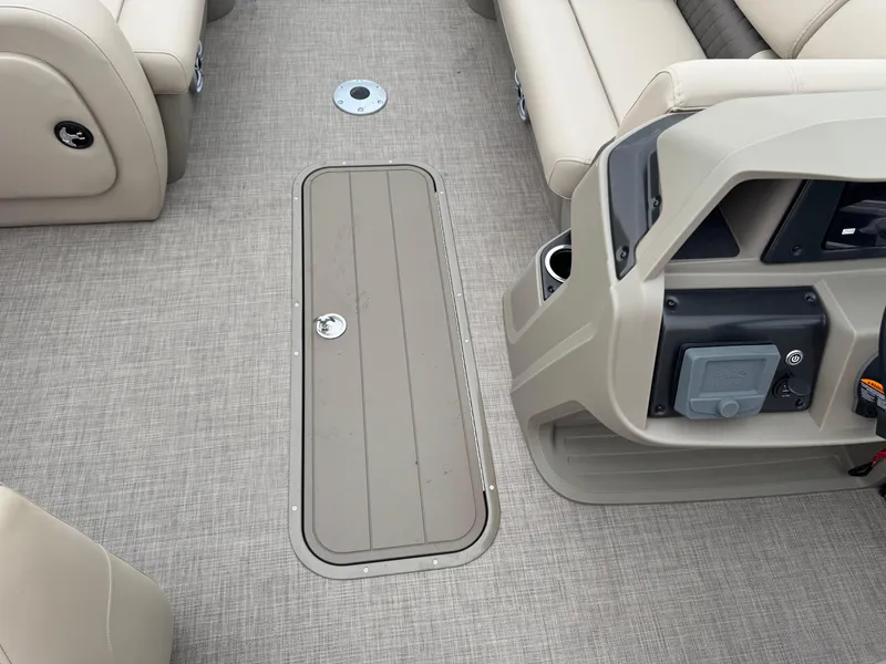 Slide: The Image of 2025 Sun Tracker SportFish 22 XP3 interior with beige seating and control panel. - 13