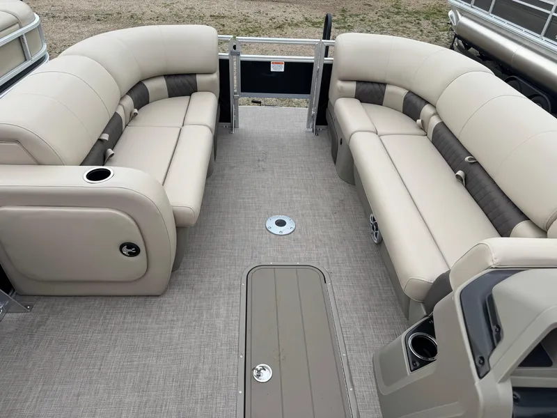 Slide: The Image of 2025 Sun Tracker SportFish 22 XP3 pontoon boat interior with beige seating and cup holders. - 14