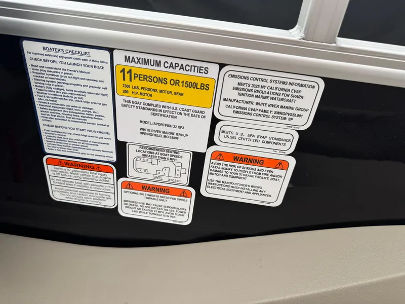 Slide: The Image of 2025 Sun Tracker SportFish 22 XP3 capacity and safety labels on boat interior. - 15