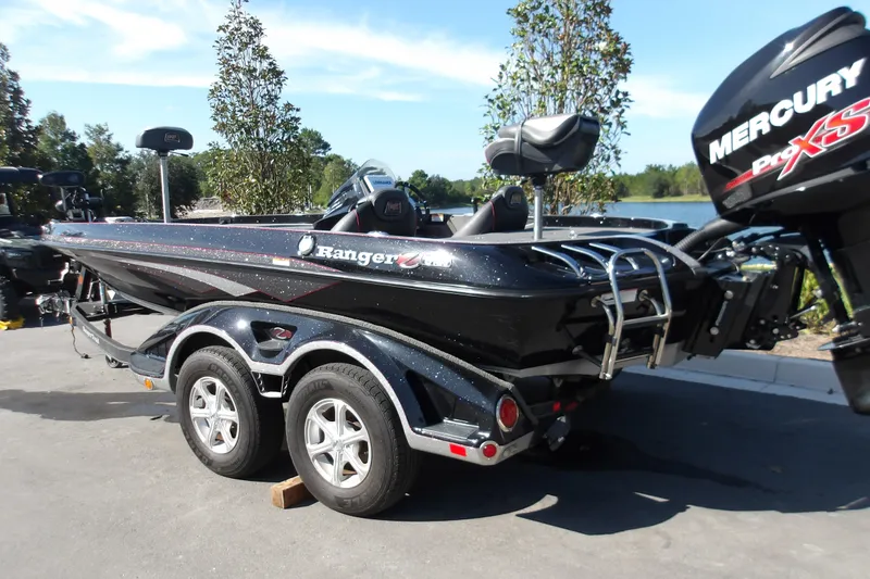 Slide: The Image of 2017 Ranger Z518c boat with Mercury Pro XS engine, parked on a trailer by a lake. - 0