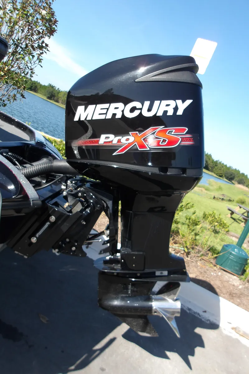 Slide: The Image of 2017 Ranger Z518c with Mercury Pro XS outboard motor by a lake. - 2