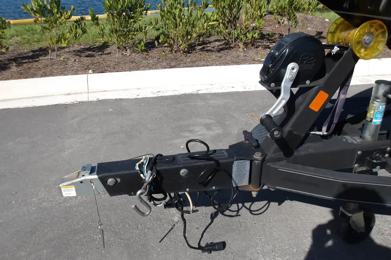 Slide: The Image of 2017 Ranger Z518c boat trailer hitch with winch, parked on asphalt near greenery. - 9