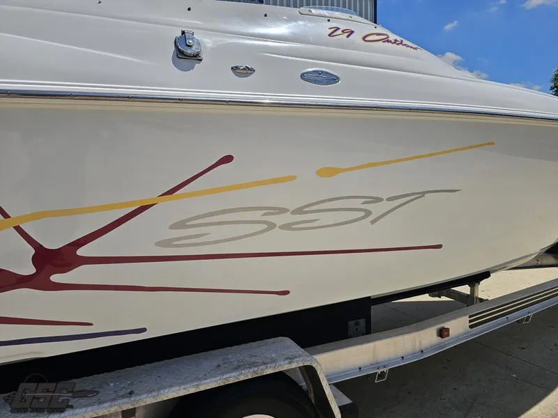 Slide: The Image of 2000 Baja 29 Outlaw boat with SST graphics on trailer, side view. - 12