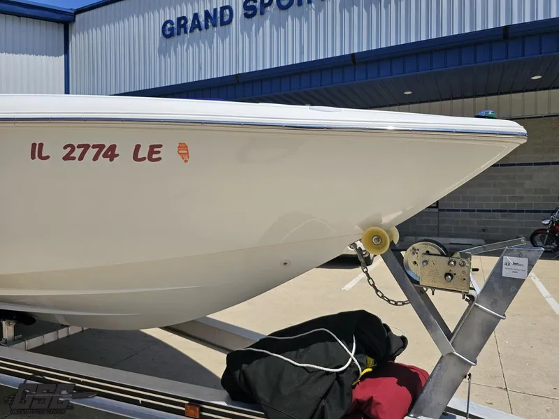 Slide: The Image of 2000 Baja 29 Outlaw boat on trailer outside Grand Sport Center. - 18