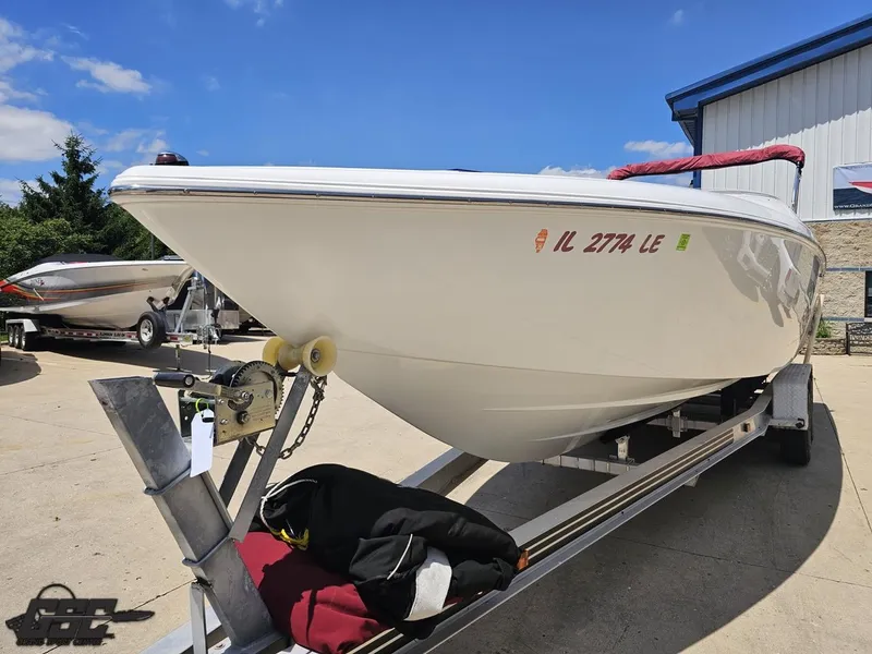 Slide: The Image of 2000 Baja 29 Outlaw boat on trailer, parked outdoors under clear sky. - 22