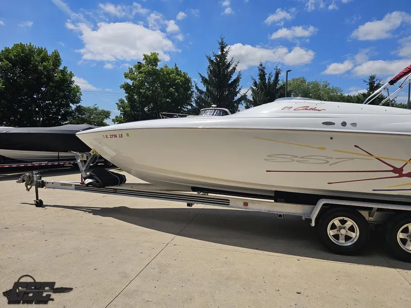 Slide: The Image of 2000 Baja 29 Outlaw boat on trailer under clear blue sky. - 28