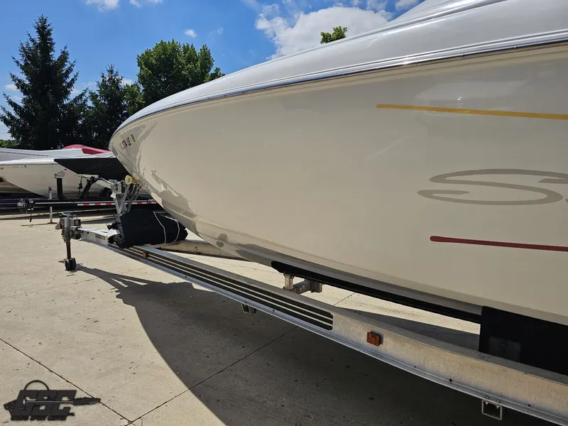 Slide: The Image of 2000 Baja 29 Outlaw boat on trailer under clear blue sky. - 33