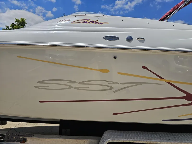 Slide: The Image of 2000 Baja 29 Outlaw boat with colorful graphics under a blue sky. - 34