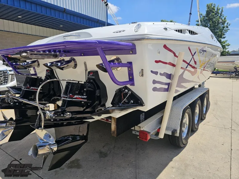 Slide: The Image of 2000 Baja 29 Outlaw boat on trailer, featuring dual Mercury engines and vibrant graphics. - 45