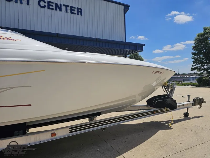 Slide: The Image of 2000 Baja 29 Outlaw boat on trailer at sport center, sunny day. - 8