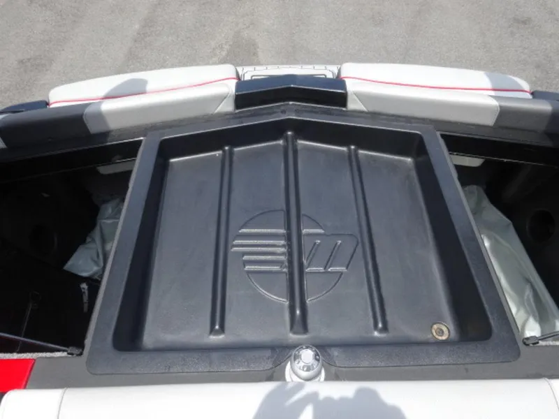 Slide: The Image of 2018 Malibu 23 LSV boat storage compartment with logo, featuring sleek design and ample space. - 12