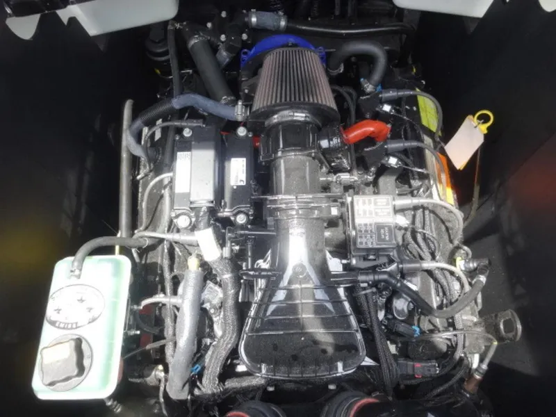 Slide: The Image of Engine compartment of a 2018 Malibu 23 LSV boat, showcasing intricate mechanical components. - 13