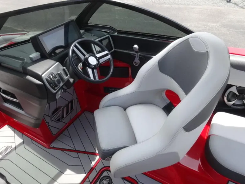 Slide: The Image of 2018 Malibu 23 LSV boat interior with steering wheel and modern dashboard. - 14